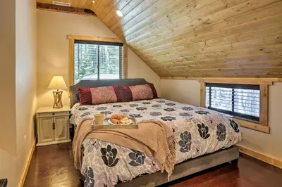 a bedroom with a large bed with a wooden ceiling at 5 Mi to Skiing! Family Getaway Near Donner Lake in Truckee