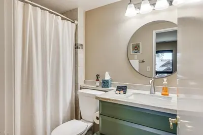 a bathroom with a toilet and a sink and a mirror at 1 Mi to Lake Tahoe Home with Hot Tub and Decks in Tahoe City
