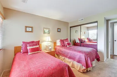a bedroom with two beds and a mirror at 1 Mi to Lake Tahoe Home with Hot Tub and Decks in Tahoe City