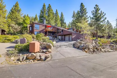 a home in the woods with a driveway at 1 Mi to Lake Tahoe Home with Hot Tub and Decks in Tahoe City