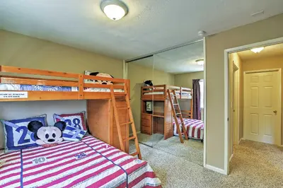 a bedroom with two bunk beds and a mirror at Waterfront Discovery Bay Home Outdoor Bar and Dock in Discovery Bay