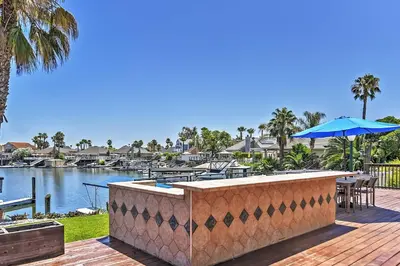 a patio with a pool and a table and an umbrella at Waterfront Discovery Bay Home Outdoor Bar and Dock in Discovery Bay