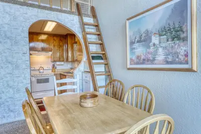 a kitchen with a wooden table and a ladder at Heavenly View 4 U in Stateline
