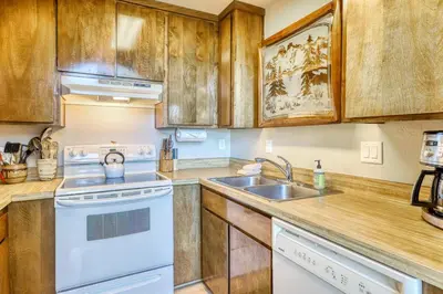 a kitchen with white appliances and wooden cabinets at Heavenly View 4 U in Stateline
