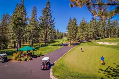 an aerial view of a golf course with people playing golf at Charming Mountain Chalet in Truckee