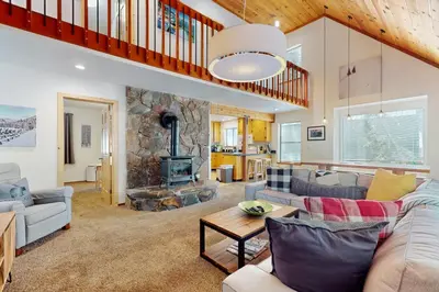 a living room with a couch and a fireplace at Charming Mountain Chalet in Truckee