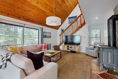 a living room with a couch and a fireplace at Charming Mountain Chalet in Truckee