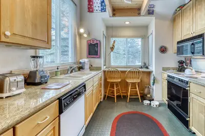 a kitchen with a sink and two chairs in it at Spike's Place in Truckee