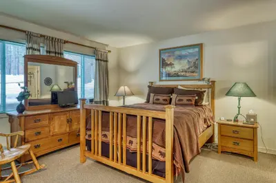 a bedroom with a bed and a large mirror at Spike's Place in Truckee