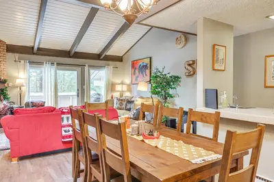 a dining room and living room with a table and chairs at 1 Mi to Diamond Peak Ski Resort Forest-View Condo in Incline Village