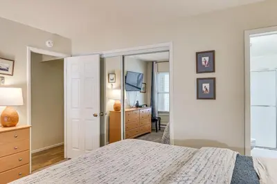 a bedroom with a bed and a dresser and a mirror at 1 Mi to Diamond Peak Ski Resort Forest-View Condo in Incline Village