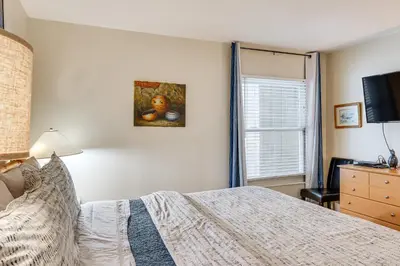 a bedroom with a bed and a dresser and a window at 1 Mi to Diamond Peak Ski Resort Forest-View Condo in Incline Village