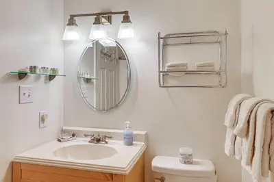 a bathroom with a sink and a mirror and a toilet at 1 Mi to Diamond Peak Ski Resort Forest-View Condo in Incline Village
