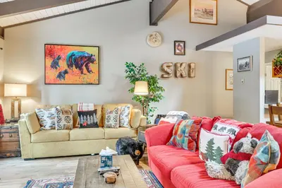 a living room with a red couch and couches at 1 Mi to Diamond Peak Ski Resort Forest-View Condo in Incline Village