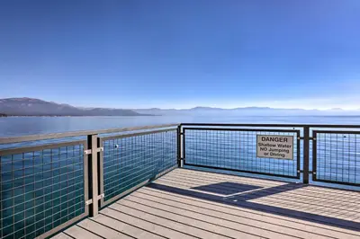 a boardwalk with a danger sign on it next to the water at Carnelian Bay Home with Hot Tub Near Tahoe Skiing in Carnelian Bay