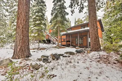 a house in the woods in the snow with trees at Lake Tahoe Family Home with Hot Tub and Game Room! in Incline Village