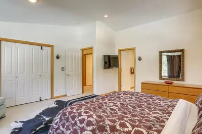 a bedroom with a bed and a tv on the wall at 7 Mi to Northstar Resort Tahoe Vista Family Cabin in Tahoe Vista