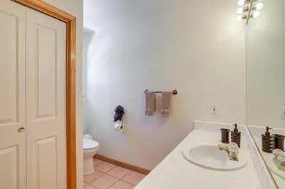 a white bathroom with a sink and a toilet at 7 Mi to Northstar Resort Tahoe Vista Family Cabin in Tahoe Vista
