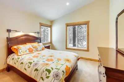 a bedroom with a bed and a desk and two windows at 4 Mi to Skiing Truckee Escape with Deck in Truckee
