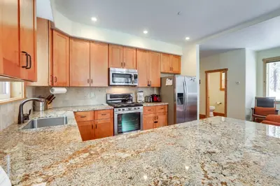 a kitchen with wooden cabinets and a granite counter top at 4 Mi to Skiing Truckee Escape with Deck in Truckee