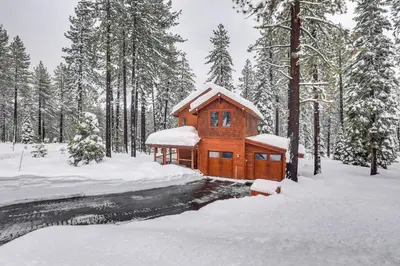 a wooden cabin in the woods in the snow at 4 Mi to Skiing Truckee Escape with Deck in Truckee