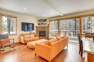 a living room with orange chairs and a fireplace at 4 Mi to Skiing Truckee Escape with Deck in Truckee