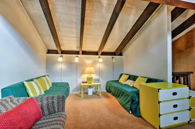 a living room with two green couches and a table at Ski Condo with Beach Access and 2 Mi to Diamond Peak! in Incline Village