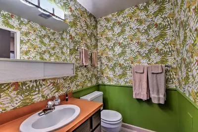 a bathroom with a sink and a green wall at Ski Condo with Beach Access and 2 Mi to Diamond Peak! in Incline Village