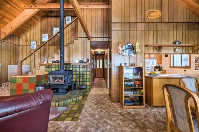 a living room with a stove in a barn at Near Hiking and Skiing Bear Valley Cabin! in Tamarack