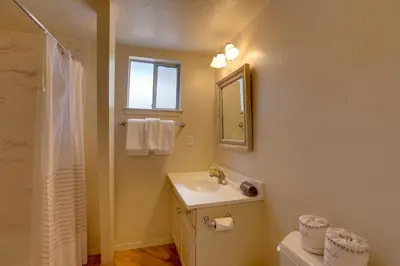 a bathroom with a sink and a mirror and a toilet at Near Skiing and Hiking Carnelian Bay Cabin in Carnelian Bay
