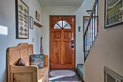 a hallway with a wooden door and a stair case at Spacious and Cozy Condo, 1 Block To The Village in Mammoth Lakes