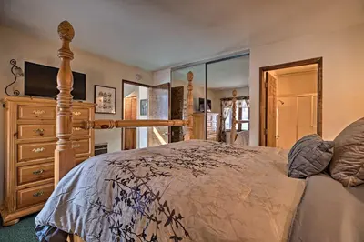 a bedroom with a bed and a dresser at Spacious and Cozy Condo, 1 Block To The Village in Mammoth Lakes
