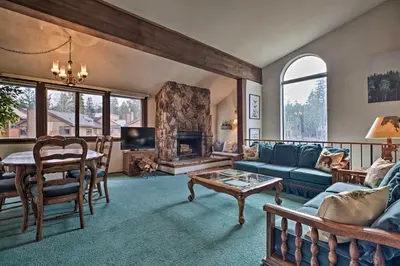 a living room with a blue couch and a fireplace at Spacious and Cozy Condo, 1 Block To The Village in Mammoth Lakes