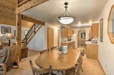 a kitchen and dining room with a wooden table at Cabin with Hot Tub and BBQ Deck Less Than 4 Mi to Donner Lake! in Truckee