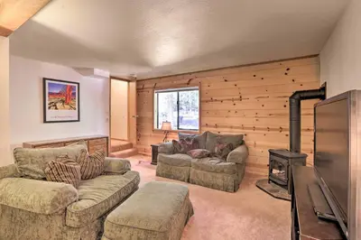 a living room with two couches and a fireplace at Cabin with Hot Tub and BBQ Deck Less Than 4 Mi to Donner Lake! in Truckee
