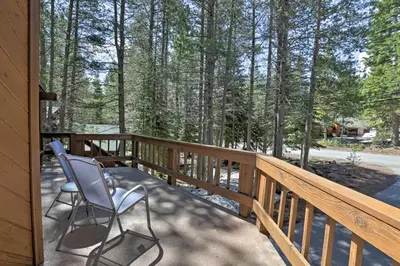 two chairs sitting on the porch of a house at Cabin with Hot Tub and BBQ Deck Less Than 4 Mi to Donner Lake! in Truckee