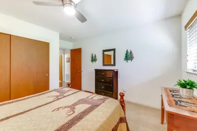 a bedroom with a bed and a dresser and a desk at Mountain Paradise about 1 Mile to Pine Mountain Lake! in Groveland