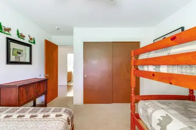 a bedroom with two bunk beds and a closet at Mountain Paradise about 1 Mile to Pine Mountain Lake! in Groveland