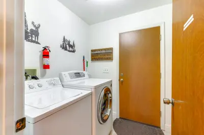 a bathroom with a washing machine and a sink at Mountain Paradise about 1 Mile to Pine Mountain Lake! in Groveland