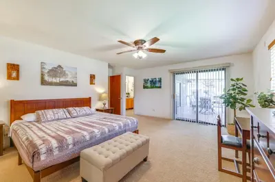 a bedroom with a bed and a ceiling fan at Mountain Paradise about 1 Mile to Pine Mountain Lake! in Groveland