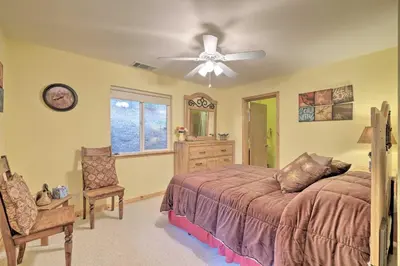 a bedroom with a bed and a ceiling fan at Walk to Big Trees State Park Cabin with Deck! in Dorrington