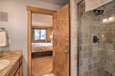 a bathroom with a shower and a bedroom with a bed at North Lake Tahoe Cabin 4 Mi to the Beach! in Tahoe Vista