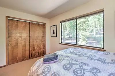 a bedroom with a bed and a large window at North Lake Tahoe Cabin 4 Mi to the Beach! in Tahoe Vista