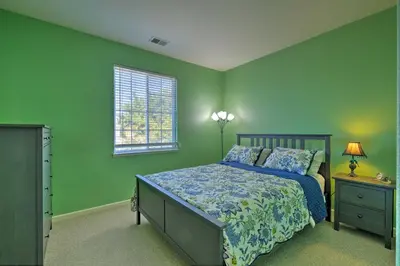 a bedroom with green walls and a bed and a window at Family-Friendly Tracy House with Patio and Grill! in Tracy