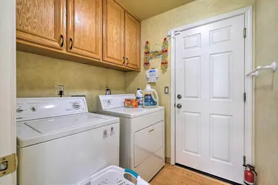 a small laundry room with a washer and dryer at Family-Friendly Tracy House with Patio and Grill! in Tracy