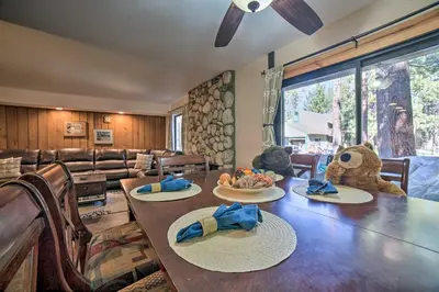 a dining room with a table and a stuffed bear at Mammoth Lakes Condo, Walk to Shuttle and Village in Mammoth Lakes