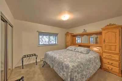 a bedroom with a bed and a wooden cabinet at Cabin in Natl Forest 35 Min to Boreal Resort in Colfax