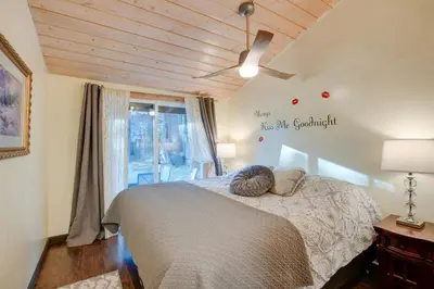 a bedroom with a bed with a ceiling fan and a window at 3 Mi to Heavenly Mountain Resort Home with Deck in Stateline