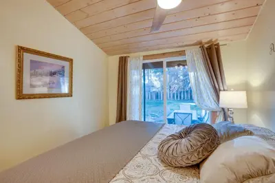 a bedroom with a bed with a large window at 3 Mi to Heavenly Mountain Resort Home with Deck in Stateline