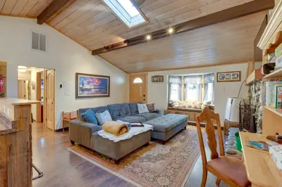 a living room with a blue couch and a chair at 3 Mi to Heavenly Mountain Resort Home with Deck in Stateline